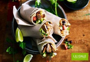 Chicken burrito served with lime wedges