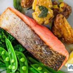 Crisy skin salmon served with smashed potatoes, snow peas and broccoli